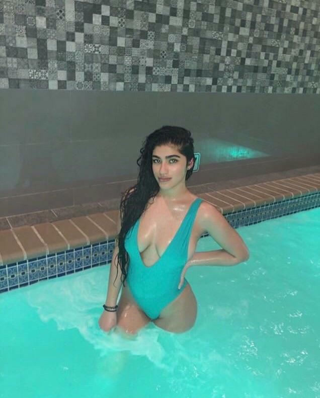 Teasing her tits in the pool