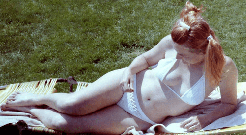 Vintage 1980s redhead sunning.....