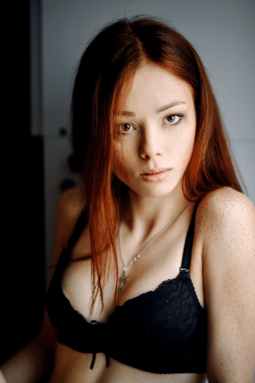 Red hair, freckles, black bra