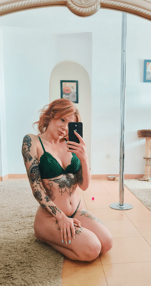 Just a tattooed redhead with her green lingerie