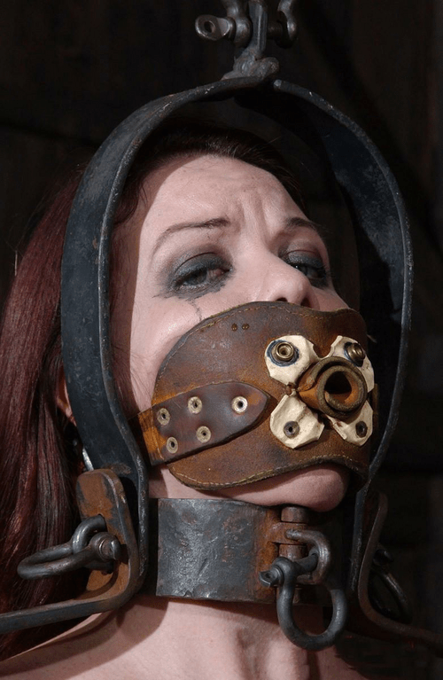 Medievally gagged in a dungeon.